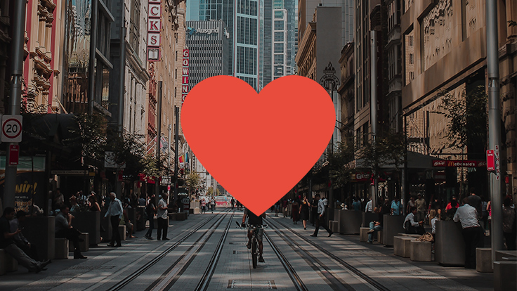 Image of a red heart graphic superimposed on close up of Sydney CBD busy George Street with tram tracks and shoppers