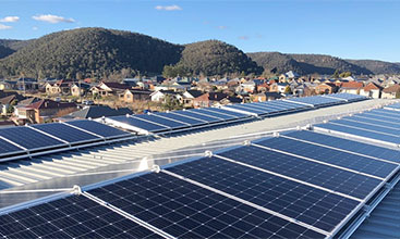 Rooftop view of solar panels and landscape